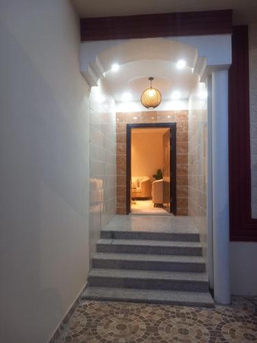 a hallway with stairs leading to a room at شقق رومكس Rumex apartments in Al-Salam