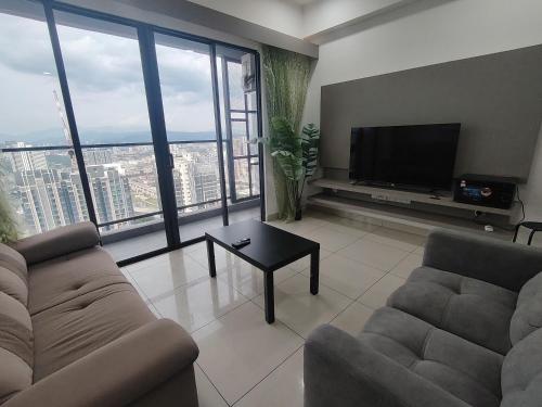 a living room with a couch and a flat screen tv at Trion Residence Kuala Lumpur by Centrix in Kuala Lumpur
