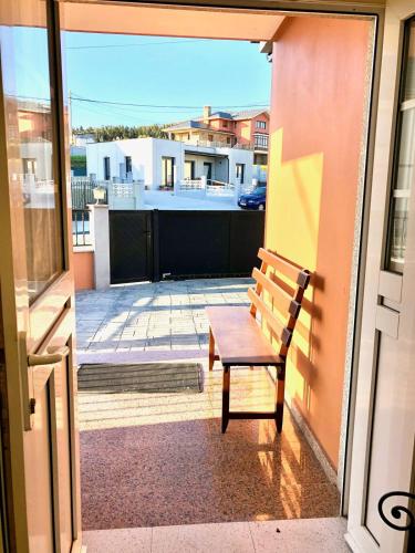 a bench sitting on the balcony of a building at The Cliffs - Le nid de Martina in O Barqueiro