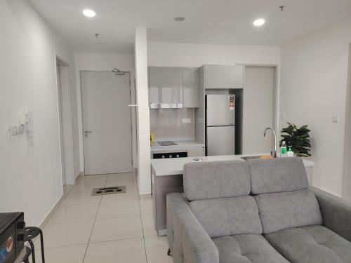 a living room with a couch and a kitchen at Trion Residence Kuala Lumpur by Centrix in Kuala Lumpur