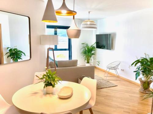 a living room with a table and a couch at The Cliffs - Sunset Village Beach 1A in Viveiro