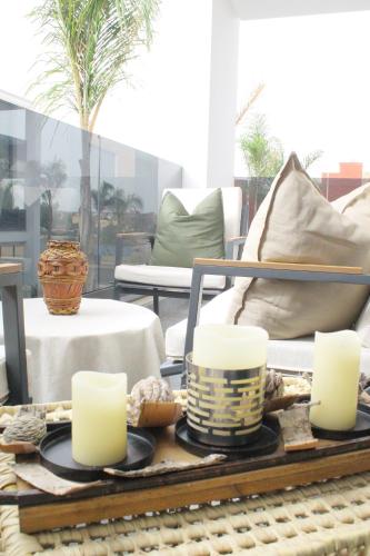 a table with candles on top of a table at Azra Mila Appart luxe famille uniquement in Saidia 