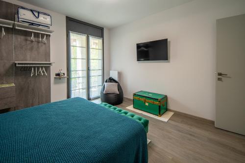 a bedroom with a bed and a television in a room at Locazione Turistica L'Aurora in Alba