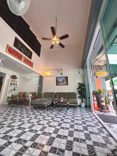 a lobby with couches and a ceiling fan at Sherly 888 Hotel in Hua Hin