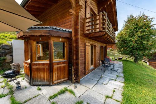 a house with a large wooden door on a patio at Chalet Colonia in La Tzoumaz
