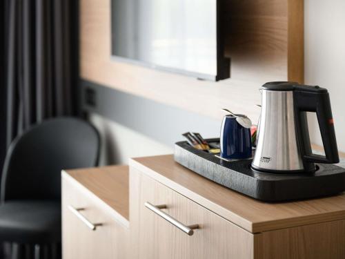 a coffeemaker sitting on top of a counter in a room at Novotel Szeged in Szeged