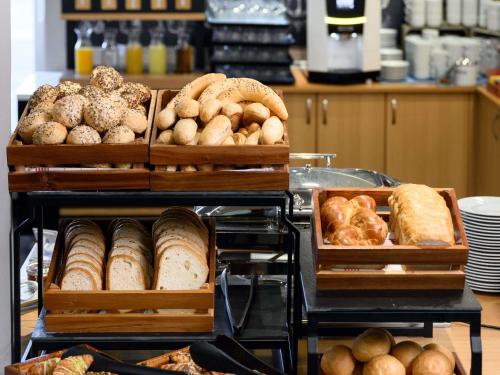 a bakery with various types of bread and pastries at Novotel Szeged in Szeged