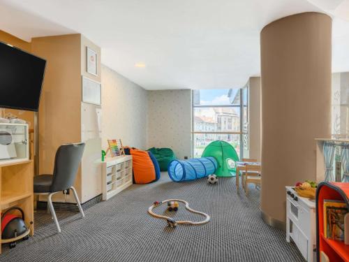 a childs room with a play area with a play implement at Novotel Szeged in Szeged