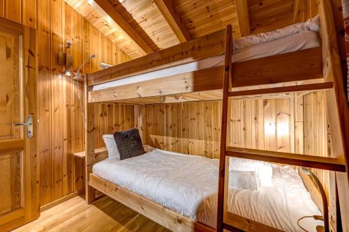 a bedroom with two bunk beds in a cabin at Chalet Colonia in La Tzoumaz