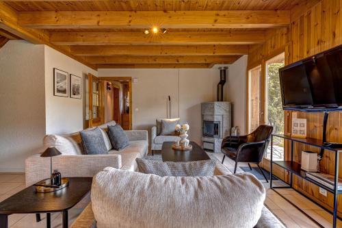 a living room with a couch and a table at Chalet Colonia in La Tzoumaz