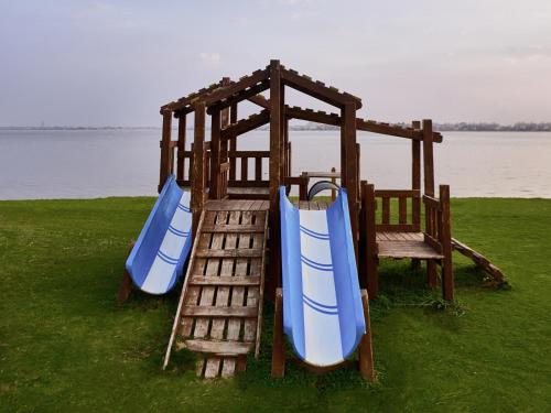 a playground with two slides and a swing set at Mercure Ismailia Forsan Island in Ismailia