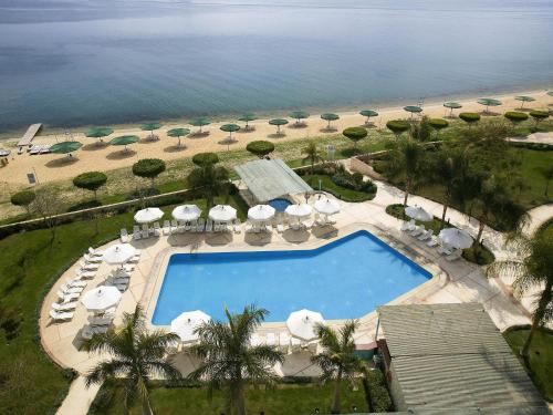 an aerial view of a swimming pool and the beach at Mercure Ismailia Forsan Island in Ismailia