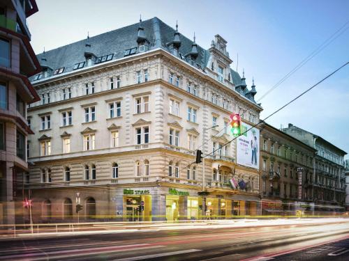 a large building on a street with a traffic light at Ibis Styles Budapest Center in Budapest