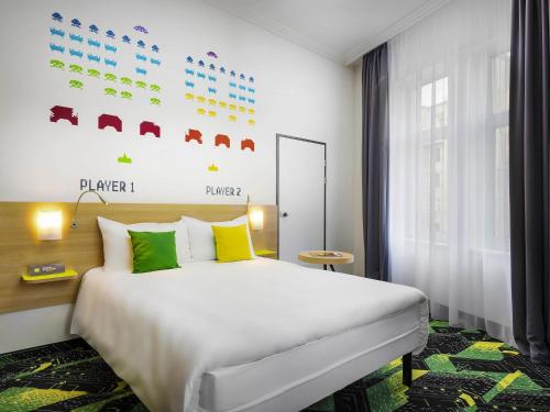 a hotel room with a bed and a window at Ibis Styles Budapest Center in Budapest