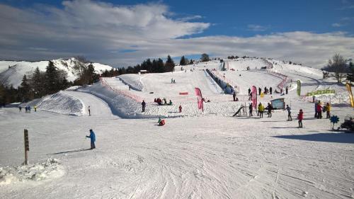 a group of people skiing down a snow covered slope at La Maison Garrap dans le val d'Azun in Arrens-Marsous