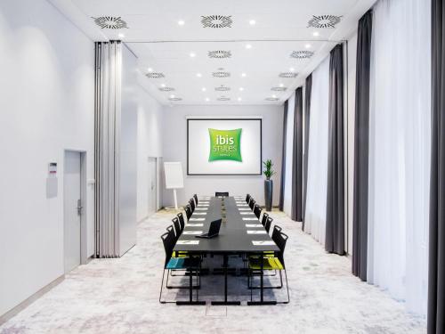 a long conference room with a long table and chairs at Ibis Styles Budapest Center in Budapest