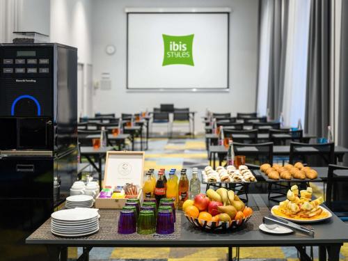 a table with bowls of fruit and drinks on it at Ibis Styles Budapest Center in Budapest