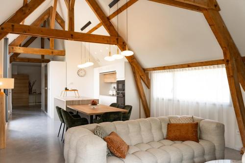 a living room with a white couch and a table at La Louvière in Villard-de-Lans