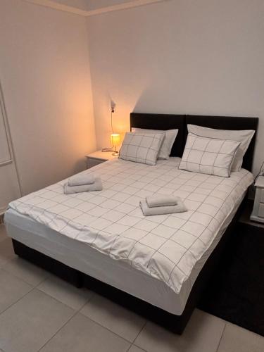 a bedroom with a large bed with two pillows on it at Zeravica Rooms B&B in Sremski Karlovci