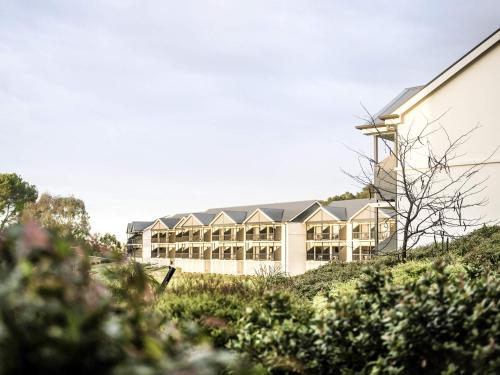 a large building on top of a hill at Novotel Barossa Valley Resort in Rowland Flat