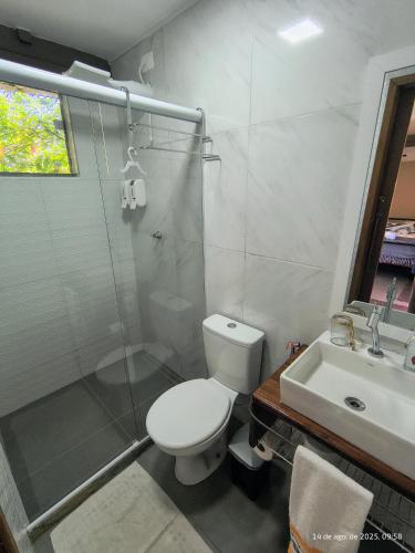 a bathroom with a toilet and a shower and a sink at Pousada Container Eco Manguinhos in Manguinhos