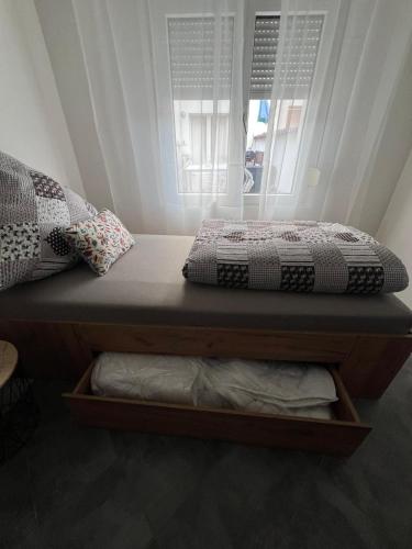 a bed with two pillows sitting on top of it at Winningen Ferienwohnung Beste Lage Terrasse in Winningen