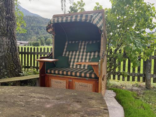 a gazebo chair sitting in a yard at Rosenhof am See Ferienwohnung Alpenrose in Thiersee
