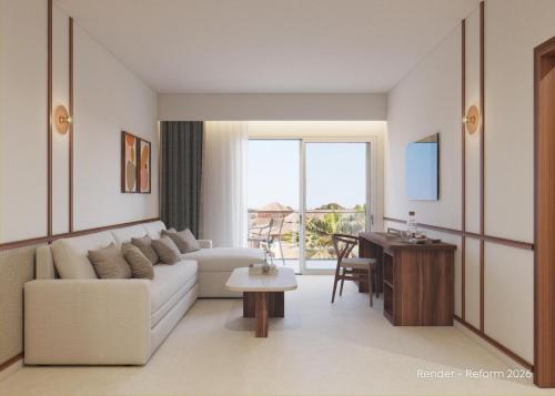 a living room with a white couch and a table at Zafiro Can Picafort in Can Picafort