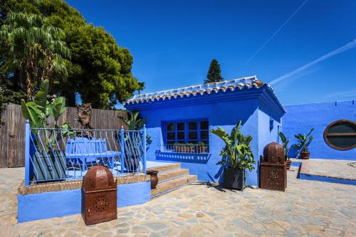a blue house with a table in front of it at Cortijo Boutique Marbella in Marbella