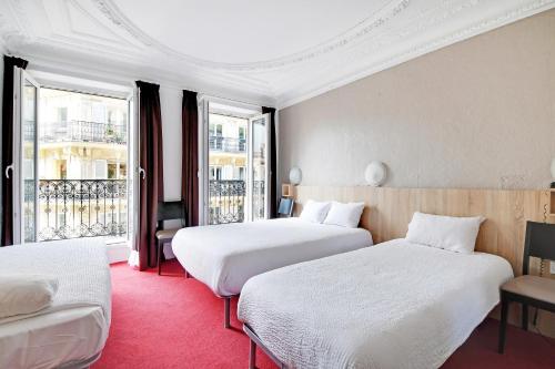 a hotel room with two beds and a balcony at Altona in Paris