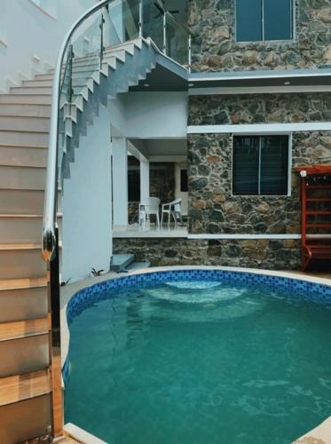 a swimming pool in front of a house at Prarambha The Stone House in Bolpur