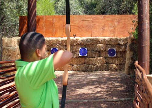 a young boy holding a baseball bat at Piekenierskloof Mountain Resort by Dream Resorts in Citrusdal