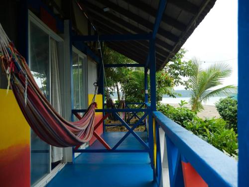 a hammock on the porch of a house at Iracas del Mar in Termales - agua caliente - nuqui