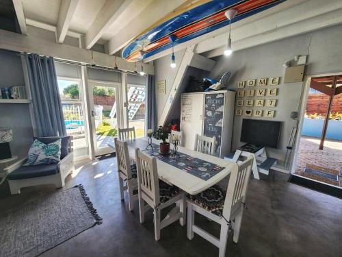 a dining room with a white table and chairs at Sedgefield Holiday Accommodation in Sedgefield