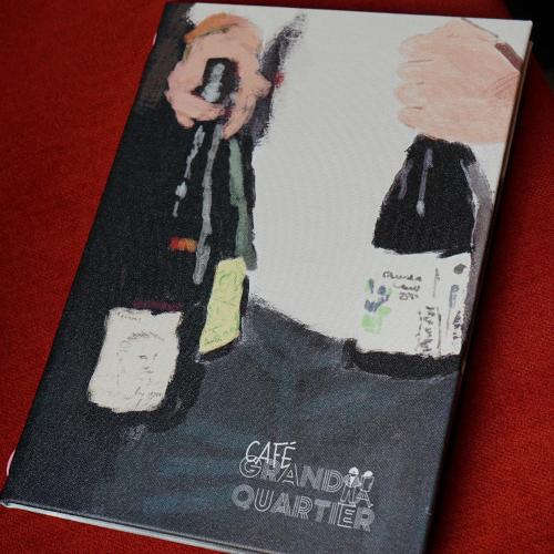 a book with a picture of a man on a phone at Le Grand Quartier in Paris