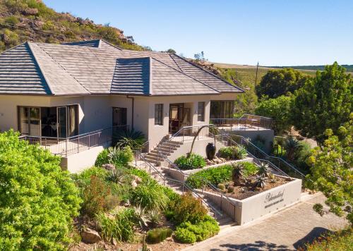 a house with stairs and plants in front of it at Piekenierskloof Mountain Resort by Dream Resorts in Citrusdal