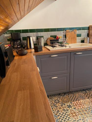 a kitchen with a sink and a counter top at Chalet Loft pour escapades en bords de Loire in Monteaux