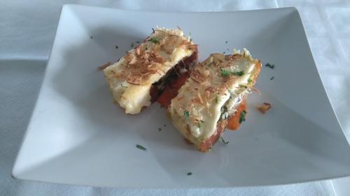 two pieces of food on a white plate at Hotel Rural La Dehesilla in Barajas de Gredos