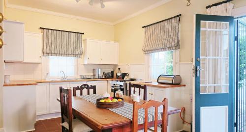 eine Küche mit einem Tisch mit einer Obstschale darauf in der Unterkunft Karoo House Collection - 54 Middle in Graaff-Reinet