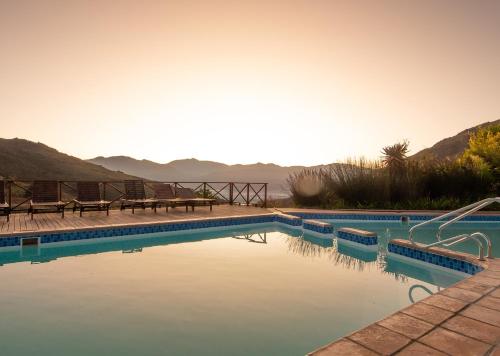 a swimming pool with a view of the mountains at Piekenierskloof Mountain Resort by Dream Resorts in Citrusdal