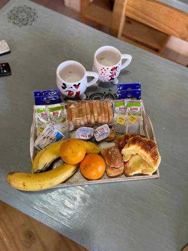a tray of breakfast food and two cups of coffee at Cabañas Don Quirino II in Concordia