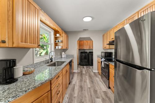 a kitchen with wooden cabinets and a stainless steel refrigerator at Stuart Ranch Private Getaway in Stuart