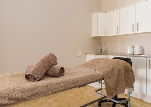 a hospital bed with towels on it in a room at Piekenierskloof Mountain Resort by Dream Resorts in Citrusdal