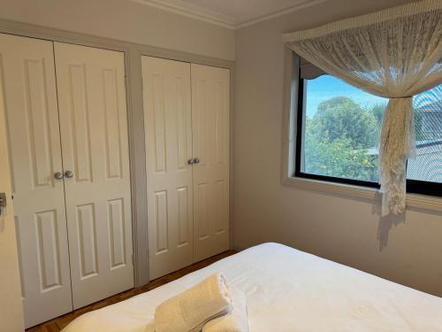 a bedroom with a bed and a large window at Geelong Chang House in Bell Post Hill