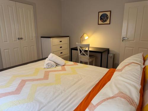 a bedroom with a large bed and a desk at Geelong Chang House in Bell Post Hill