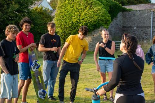 a group of young people standing in a field at Coach House in Holyhead