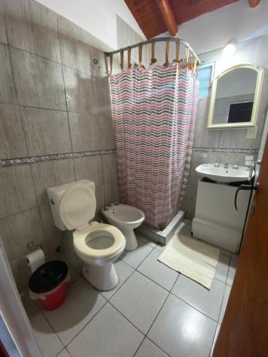 a bathroom with a toilet and a sink at Cabañas Don Quirino II in Concordia