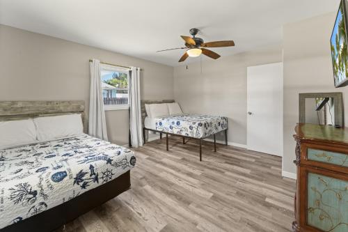 a bedroom with two beds and a ceiling fan at Stuart Ranch Private Getaway in Stuart