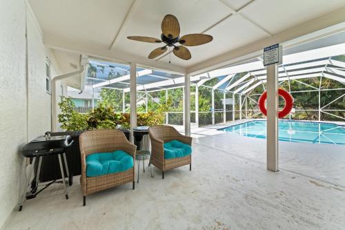 a patio with a table and chairs and a swimming pool at Stuart Ranch Private Getaway in Stuart
