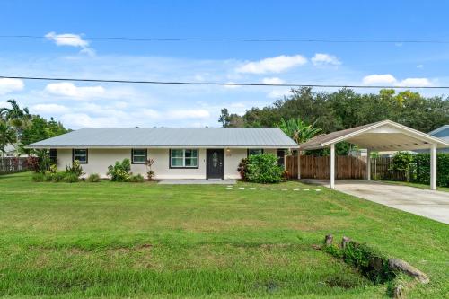 a house with a grass yard in front of it at Stuart Ranch Private Getaway in Stuart